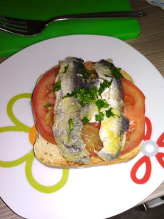 Una foto de Tosta de tomate, cebolla caramelizada y sardina