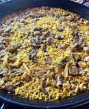 Paella with Secreto Pork, Mushrooms, and Green Garlic