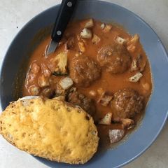 A picture of Cream of Tomato soup with Meatballs.