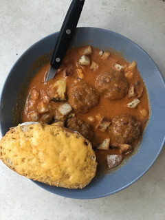 A picture of Cream of Tomato soup with Meatballs.