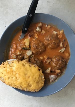 A picture of Cream of Tomato soup with Meatballs.
