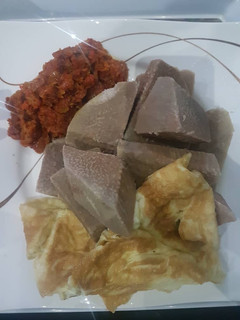 A picture of Brown yam and mince meat sauce with fried egg.