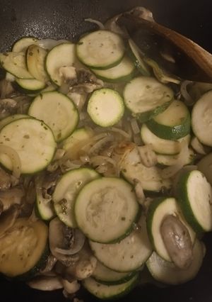 A picture of Salmon fillets with courgettes onion and mushrooms.