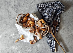 A picture of Kroštule - Delicious Croatian sweets with powdered sugar.