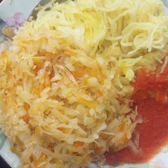 Spaghetti served with steamed cabbage and tomatoes past A picture of Spaghetti served with steamed cabbage and tomatoes past.