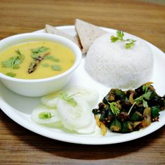 A picture of Healthy dal, chawal,bhindi fry,roti and salad.