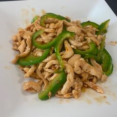 A picture of Chinese style Stir-Fry Containing Green pepper and Meat.