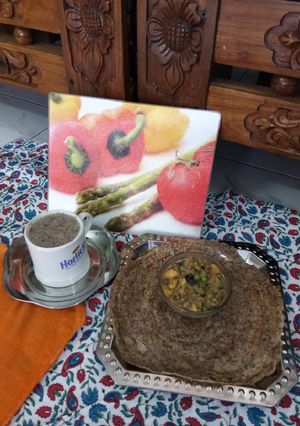 A picture of Ragi Dosa with Salad Curry and Ragi Coffee.