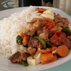 A picture of Rice and veggie sauce.