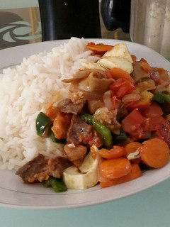 A picture of Rice and veggie sauce.