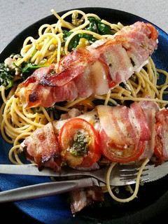 A picture of Bacon - wrapped fish with spaghetti.