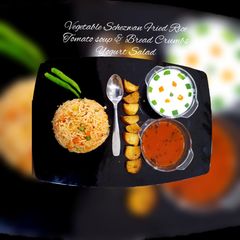 A picture of Vegetable Schezwan Fried Rice, Tomato soup & Bread Crumbs,       Yogurt salad.