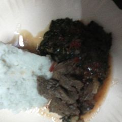 A picture of Beef stew with kales and Ugali.