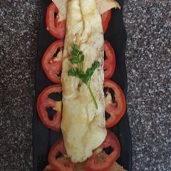 A picture of European omelet with brown bread.
