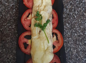 A picture of European omelet with brown bread.