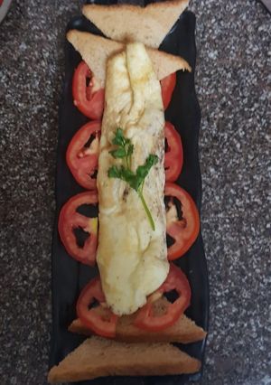 A picture of European omelet with brown bread.