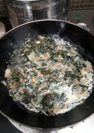 A picture of Vagi saag with badi, brinjal, pumpkins and milk.