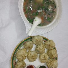 A picture of Steam chicken Momo with soup.