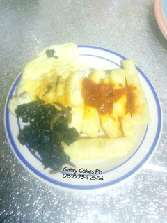 A picture of Fried yam, omelette and stir-fry leafy vegetables.