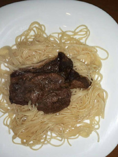 A picture of Spaghetti served with steak.
