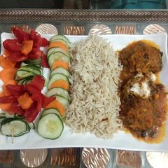 A picture of Lauki kofta curry with brown rice.