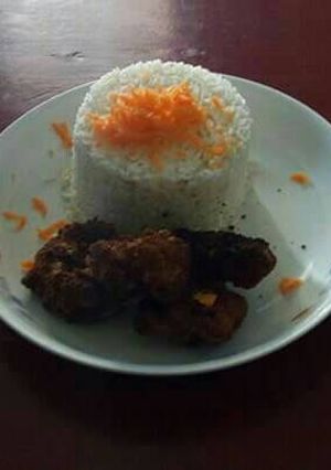 A picture of Carrot rice with deep fried chicken.