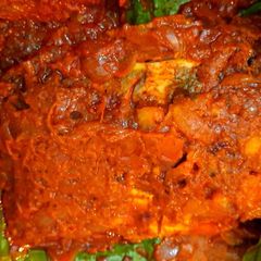 A picture of Meen Pollichathu(fish baked in spicy gravy and wrapped in banana leaves).