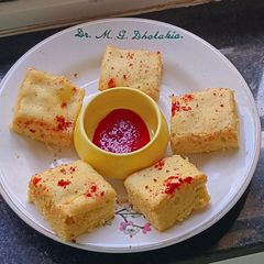 A picture of Crimson Glow Dhokla – Oil-Free Steamed Snack‌ with Red chilli Jam.
