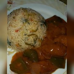 A picture of Schezwan Chicken with Fried Rice.