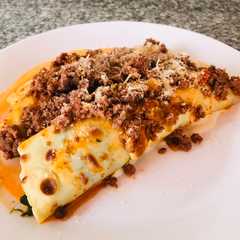Una foto de Los canelones de Maia con salsa