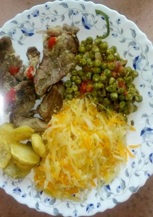 A picture of Baked potatoes and goat meat with veges.