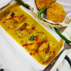 A picture of Moong dal kachori in kadhi.