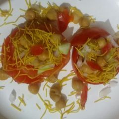 A picture of Chana chat in tomato basket.