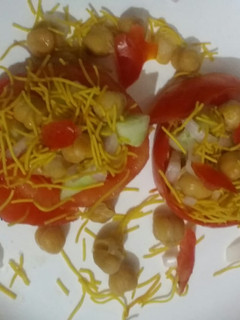 A picture of Chana chat in tomato basket.