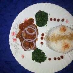 A picture of Braised rice with mutton stew and fried kales.