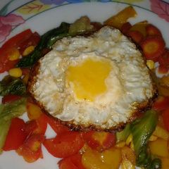 A picture of Roasted veggies with sunshine egg.