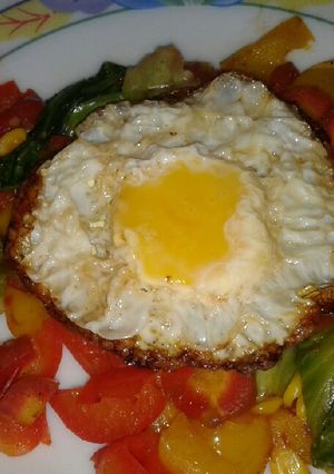 A picture of Roasted veggies with sunshine egg.