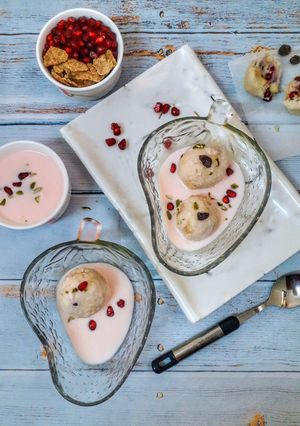A picture of Fruit balls in strawberry custard.