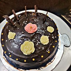 A picture of Egg less Double Truffle Cake Layered With Truffle Sauce.