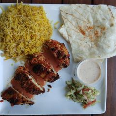 A picture of Stuff chicken breast with tomato gravy.