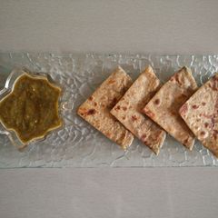 A picture of Aloo paratha with parsley chutney.