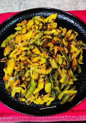 A picture of Runner beans and potato fry with onion and onion greens.