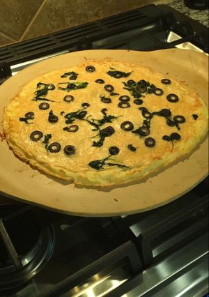 A picture of Potato Crust Pizza - with Alfredo sauce and Parmesan cheese.