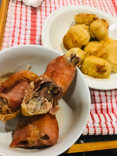 A picture of Dumplings and chicken repaid with bacon.