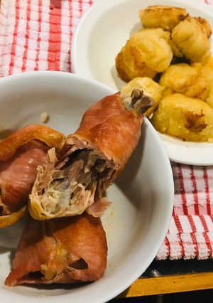 A picture of Dumplings and chicken repaid with bacon.
