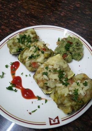 A picture of Zucchini stuffed with cheesy Guacamole.
