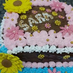 A picture of Cake with meringue buttercream frosting & Fondant flowers.
