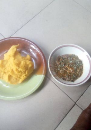 A picture of Okro soup with yellow garri.