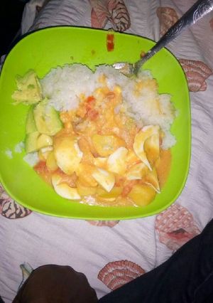 A picture of Cooked rice,potato-egg curry and avocado.