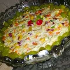A picture of Rangoli fruit salad 🥭🍑🍒🥕🥔🥒.